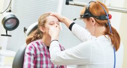 doctor examining patient's sinuses