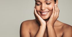 woman holding her face and smiling