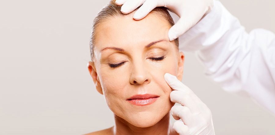 doctor examining wrinkles on patient