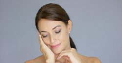 woman holding her face and smiling