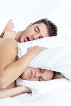 woman angry because man is snoring