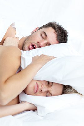 woman angry because man is snoring
