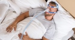 man using sleep apnea machine