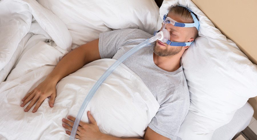 man using sleep apnea machine