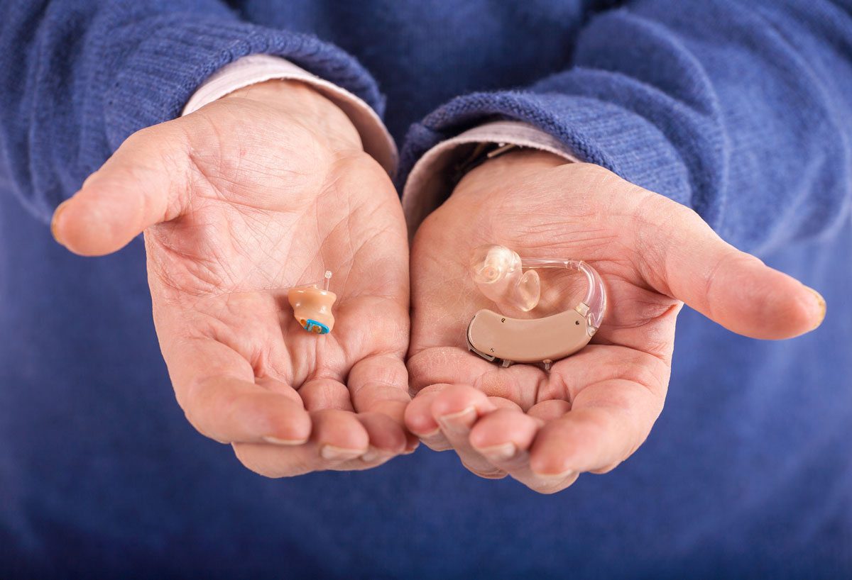 man holding hearing aids