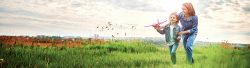 woman with daughter playing with small airplane